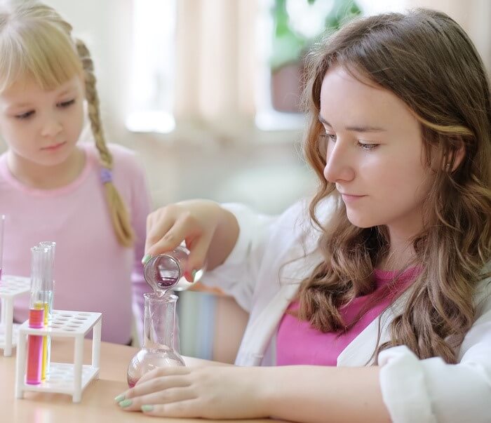 Two children doing a science experiment with test tubes