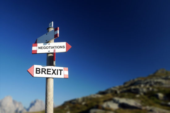 Brexit negotiations written on mountain road sign