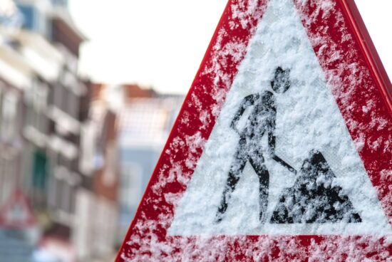 Dutch construction road sign covered with snow in winter