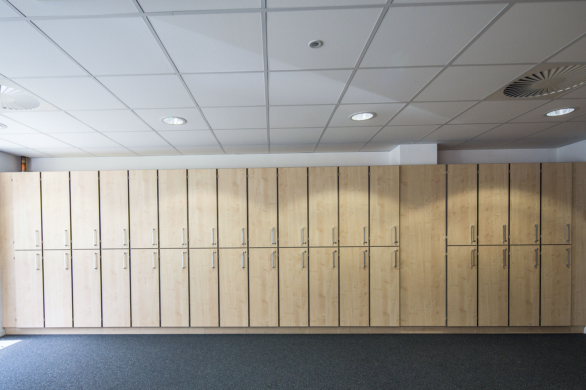 Large row of maple wood lockers for bespoke office and lab installation