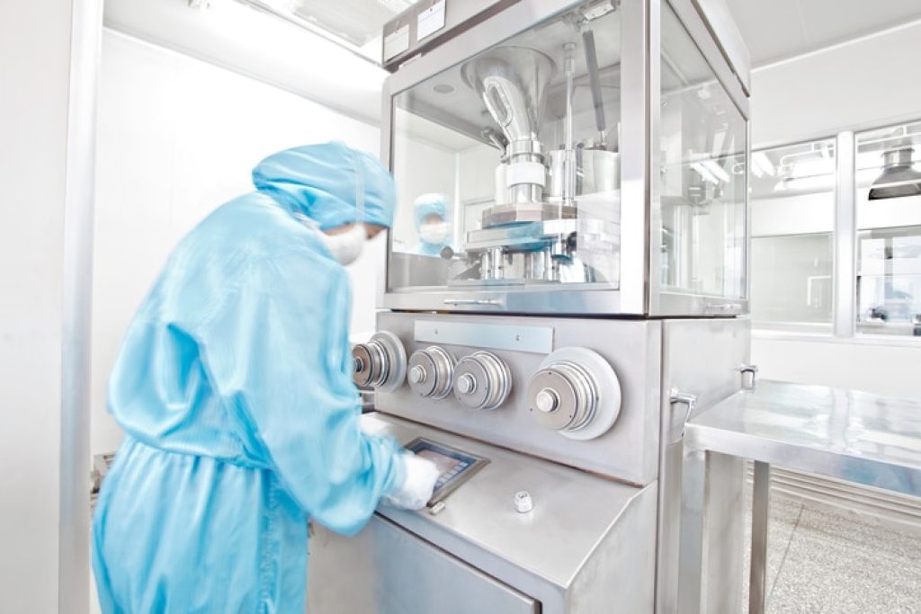a man standing at laboratory fume hood